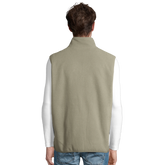 Cavaliére Unisex Microfleece Zip Vest in muted beige with a high neck, shown from the back on casual outfit model