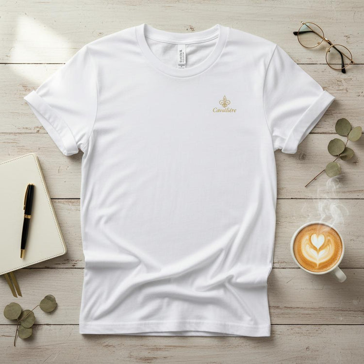 Premium Unisex Crewneck T-shirt | Cavaliére in crisp white with delicate gold embroidered logo on chest, laid flat with accessories